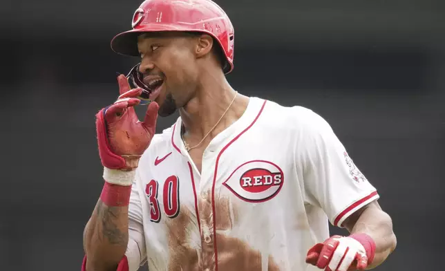 Cincinnati Reds' Will Benson gestures as he rounds the bases after hitting a solo home run during the fifth inning of a baseball game against the Chicago White Sox, Thursday, May 15, 2025, in Cincinnati. (AP Photo/Jeff Dean)
