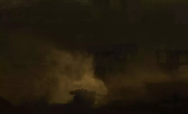 An Israeli army tank maneuvers in the Gaza Strip is seen from southern Israel, Sunday, May 4, 2025. (AP Photo/Ariel Schalit)