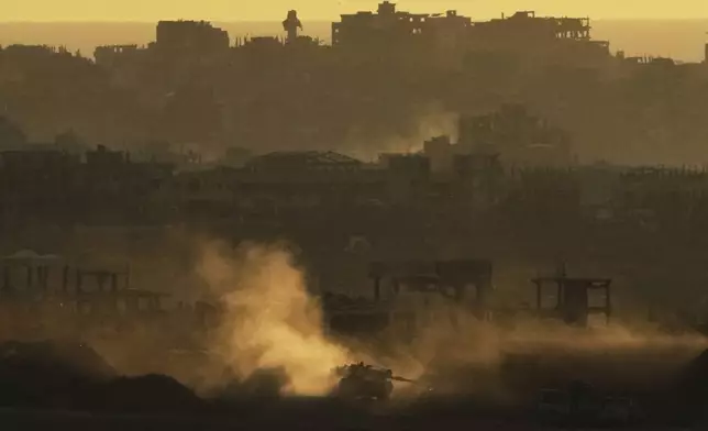 An Israeli army tank maneuvers in the Gaza Strip is seen from southern Israel, Sunday, May 4, 2025. (AP Photo/Ariel Schalit)