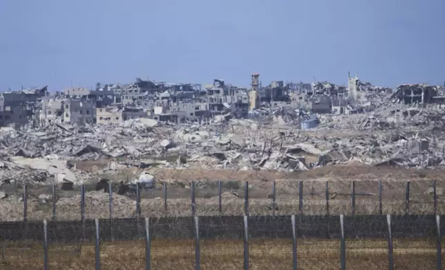 Destroyed buildings in the Gaza Strip, seen from southern Israel, Sunday, May 4, 2025. (AP Photo/Ariel Schalit)