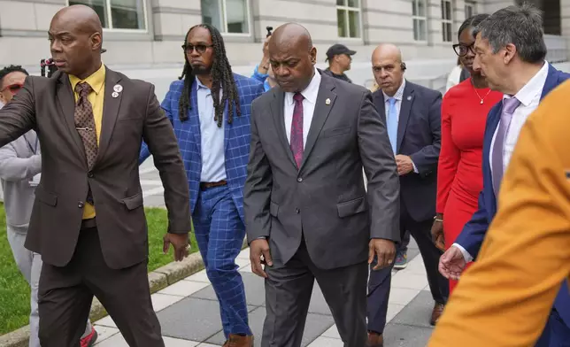 Mayor Ras Baraka, center, leaves after speaking to supporters and media after a court appearance in Newark, N.J., Thursday, May 15, 2025. (AP Photo/Seth Wenig)