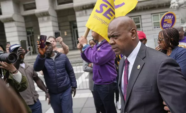 Mayor Ras Baraka, right, arrives to speak to supporters and media after a court appearance in Newark, N.J., Thursday, May 15, 2025. (AP Photo/Seth Wenig)