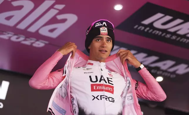 Mexico's Isaac Del Toro Romero of Uae Team Emirates Xrg celebrates with the pink jersey after the 19th stage of the Giro d'Italia cycling race, from Biella to Champoluc, Italy, Friday, May 30, 2025. (Fabio Ferrari/LaPresse via AP)