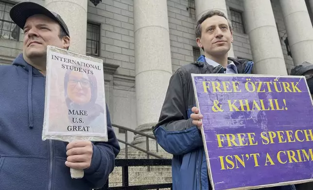 Protesters hold up signs outside court as a federal appeals court is scheduled to hear arguments in the cases of a Turkish Tufts University student who has been detained by immigration authorities for six weeks and a Palestinian student at Columbia University who was recently released from detention on Tuesday, May 6, 2025 in New York. (AP Photo/David Martin)