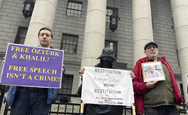 Protesters hold up signs outside court as a federal appeals court is scheduled to hear arguments in the cases of a Turkish Tufts University student who has been detained by immigration authorities for six weeks and a Palestinian student at Columbia University who was recently released from detention on Tuesday, May 6, 2025 in New York. (AP Photo/David Martin)