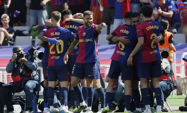Barcelona players celebrate after a goal during the La Liga soccer match between Barcelona and Real Madrid in Barcelona, Spain, Sunday, May 11, 2025. AP Photo/Joan Monfort)