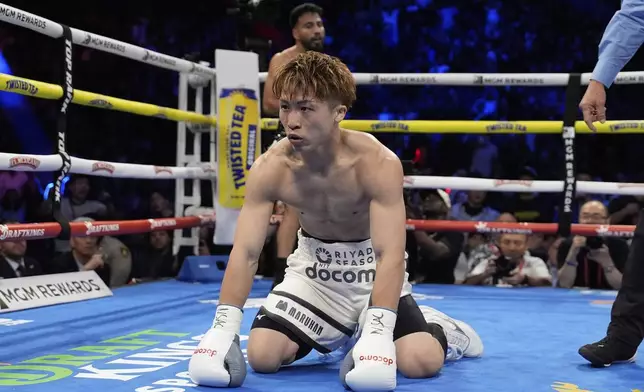 Naoya Inoue kneels on the mat after he was knocked down by Ramon Cardenas in a junior featherweight title boxing match Sunday, May 4, 2025, in Las Vegas. (AP Photo/John Locher)