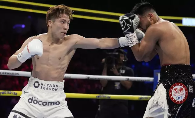 Naoya Inoue hits Ramon Cardenas in a junior featherweight title boxing match Sunday, May 4, 2025, in Las Vegas. (AP Photo/John Locher)