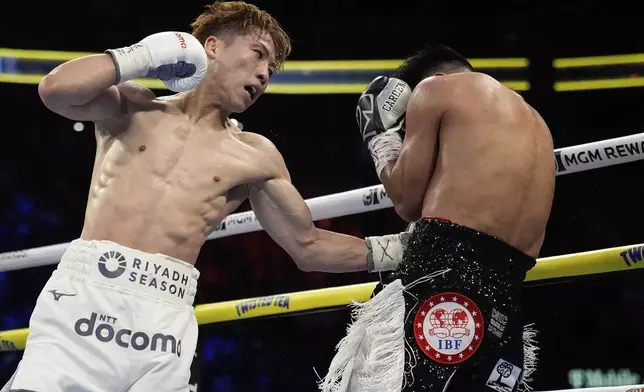 Naoya Inoue hits Ramon Cardenas in a junior featherweight title boxing match Sunday, May 4, 2025, in Las Vegas. (AP Photo/John Locher)