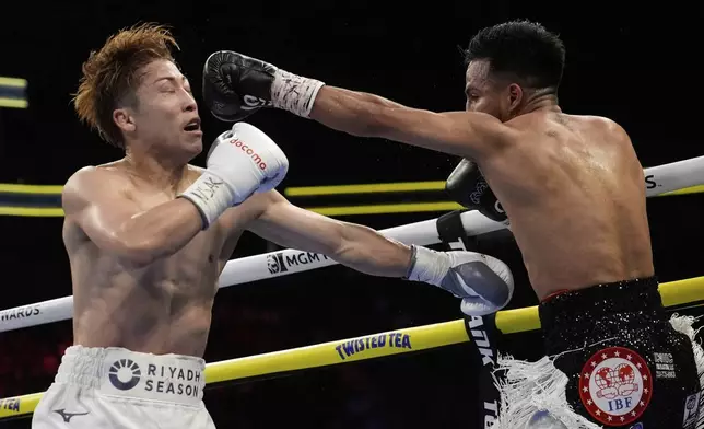 Ramon Cardenas hits Naoya Inoue in a junior featherweight title boxing match Sunday, May 4, 2025, in Las Vegas. (AP Photo/John Locher)