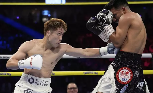 Naoya Inoue hits Ramon Cardenas in a junior featherweight title boxing match Sunday, May 4, 2025, in Las Vegas. (AP Photo/John Locher)