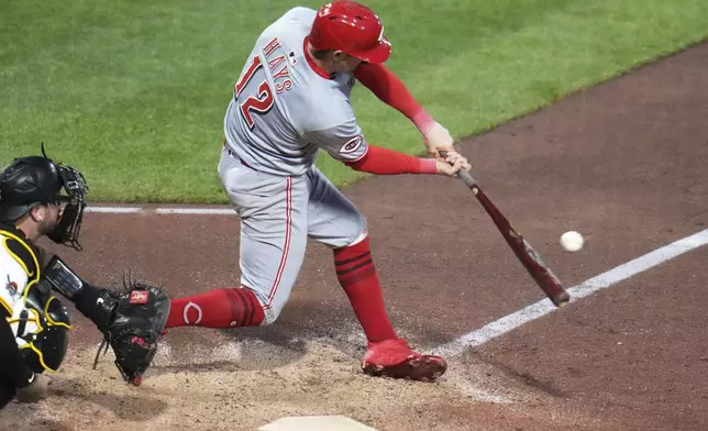 Cincinnati Reds' Austin Hays (12) singles off Pittsburgh Pirates pitcher David Bednar, driving in a run, during the eighth inning of a baseball game in Pittsburgh, Monday, May 19, 2025. (AP Photo/Gene J. Puskar)