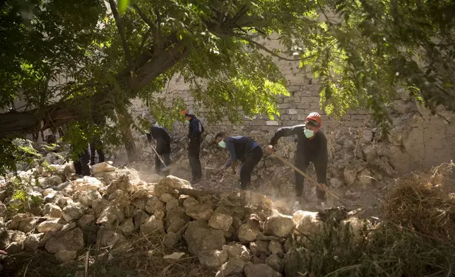 FILE - First responders dig for bodies at the site of a mass grave in Raqqa, Syria, the city that served as the de facto capital of the Islamic State group, Sept. 7, 2019. (AP Photo/Maya Alleruzzo, File)