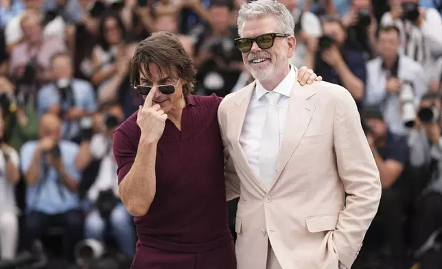 Tom Cruise, left, and director Christopher McQuarrie pose for photographers during the photo call for the film 'Mission: Impossible – The Final Reckoning' at the 78th international film festival, Cannes, southern France, Wednesday, May 14, 2025. (Photo by Scott A Garfitt/Invision/AP)