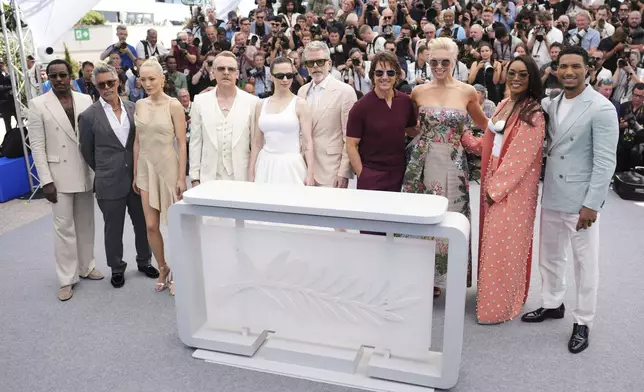 Tramell Tillman, from left, Esai Morales, Pom Klementieff, Simon Pegg, Hayley Atwell, director Christopher McQuarrie, Tom Cruise, Hannah Waddingham, Angela Bassett and Greg Tarzan Davis pose for photographers during the photo call for the film 'Mission: Impossible – The Final Reckoning' at the 78th international film festival, Cannes, southern France, Wednesday, May 14, 2025. (Photo by Scott A Garfitt/Invision/AP)