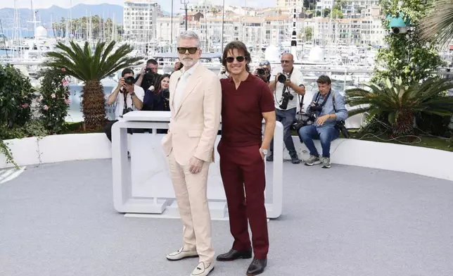 Director Christopher McQuarrie, left, and Tom Cruise pose for photographers during the photo call for the film 'Mission: Impossible – The Final Reckoning' at the 78th international film festival, Cannes, southern France, Wednesday, May 14, 2025. (Photo by Joel C Ryan/Invision/AP)