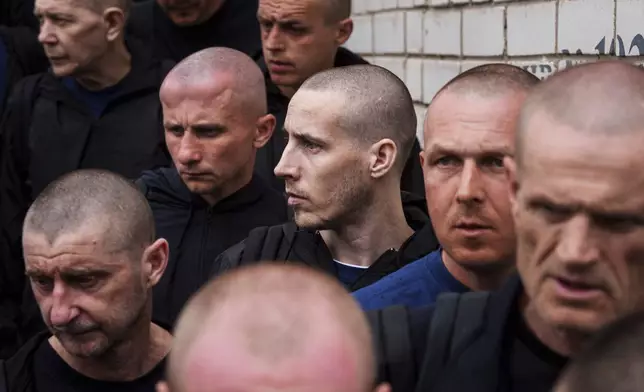 Ukrainian soldiers walk after a POWs exchange between Russia and Ukraine, in Chernyhiv region, Ukraine, Saturday, May 24, 2025. (AP Photo/Evgeniy Maloletka)