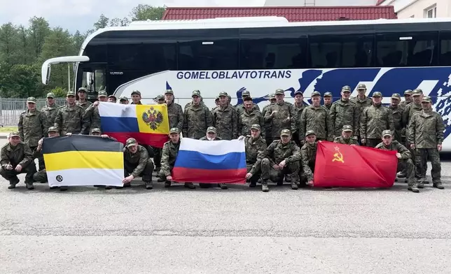 In this photo taken from a video released by Russian Defense Ministry press service, Russian servicemen pose after returning from captivity after an exchange between Russia and Ukraine, at an undisclosed location in Belarus, Saturday, May 24, 2025. (Russian Defense Ministry Press Service via AP)