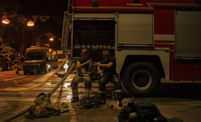 Firefighters pass water to each other after a Russian attack in Kyiv, Ukraine, Saturday, May 24, 2025 (AP Photo/Alex Babenko)