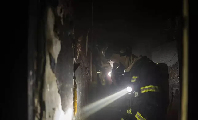 Firefighters work in residential building damaged after Russian attack in Kyiv, Ukraine, Saturday, May 24, 2025 (AP Photo/Alex Babenko)