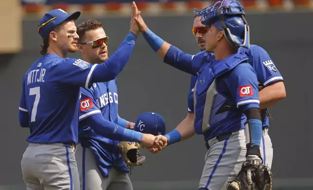 From left to right, Kansas City Royals shortstop Bobby Witt, second baseman Michael Massey, first baseman Vinnie Pasquantino and catcher Freddy Fermin celebrate after their win over the Minnesota Twins in a baseball game Sunday, May 25, 2025, in Minneapolis. (AP Photo/Bruce Kluckhohn)