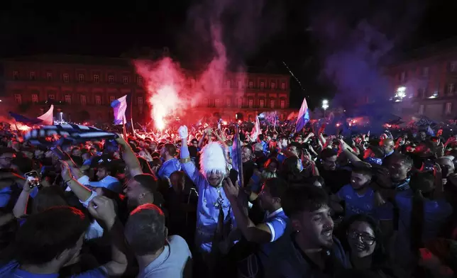 Napoli's fans celebrate as they watch the decisive match for the Italian league soccer title between Napoli and Cagliari on a giant screen set in Piazza del Plebiscito, in Naples, Italy, Friday, May 23, 2025. (AP Photo/Salvatore Laporta)