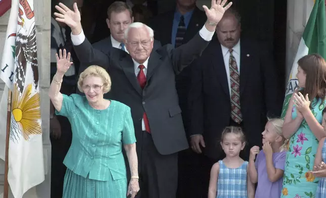 FILE - Gov. George Ryan waves as he and wife, Lura Lynn, greet to well-wishers from the steps of the Kankakee, Ill., County Courthouse in August 2001, where announced that he would not run for a second term as governor. (AP Photo/The (Kankakee) Daily Journal, File)