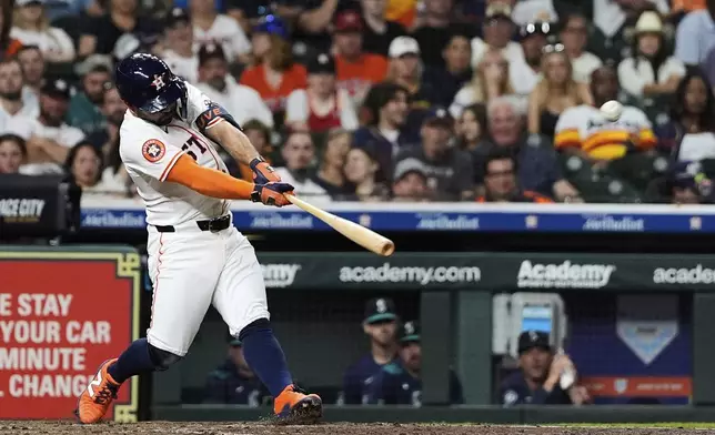 Houston Astros' Jose Altuve hits a home run during the fifth inning of a baseball game against the Seattle Mariners in Houston, Thursday, May 22, 2025. (AP Photo/Ashley Landis)