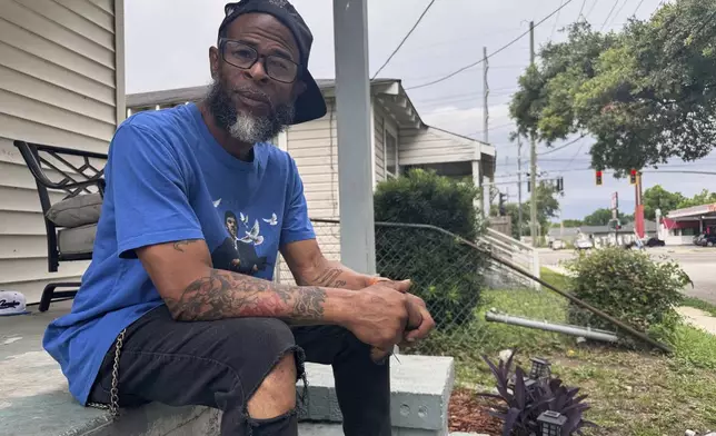 Mario Westbrook sits on his porch, May 21, 2025, in New Orleans East, where he says the community has long had negative experiences with law enforcement. (AP Photo/Jack Brook)