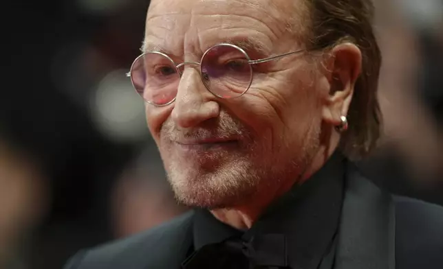 Bono poses for photographers upon arrival at the premiere of the film 'Bono: Stories of Surrender' at the 78th international film festival, Cannes, southern France, Friday, May 16, 2025. (Photo by Lewis Joly/Invision/AP)