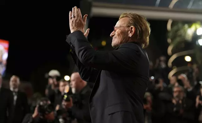 Bono poses for photographers upon arrival at the premiere of the film 'Bono: Stories of Surrender' at the 78th international film festival, Cannes, southern France, Friday, May 16, 2025. (AP Photo/Natacha Pisarenko)