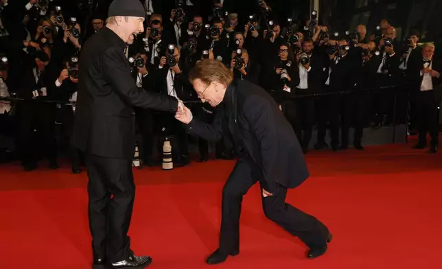 The Edge, left, and Bono pose for photographers upon arrival at the premiere of the film 'Bono: Stories of Surrender' at the 78th international film festival, Cannes, southern France, Friday, May 16, 2025. (Photo by Joel C Ryan/Invision/AP)