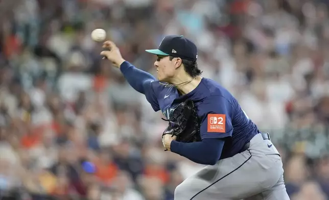 Seattle Mariners starting pitcher Bryan Woo throws against the Houston Astros during the first inning of a baseball game Saturday, May 24, 2025, in Houston. (AP Photo/David J. Phillip)