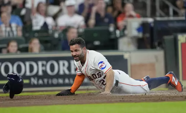 Houston Astros' Jose Altuve scores against the Seattle Mariners during the first inning of a baseball game Saturday, May 24, 2025, in Houston. (AP Photo/David J. Phillip)