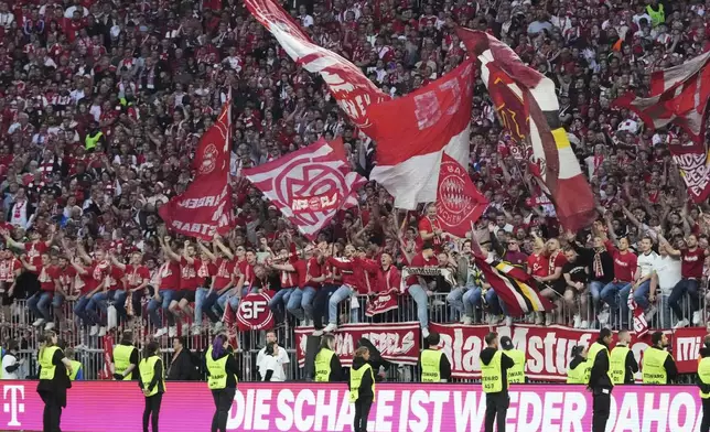 Bayern Munich fans cheer during the German Bundesliga soccer match between FC Bayern Munich and Borussia Moenchengladbach in Munich, Germany, Saturday, May 10, 2025. (AP Photo/Matthias Schrader)
