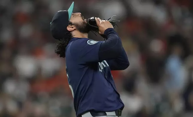 Seattle Mariners relief pitcher Andres Munoz celebrates after winning a baseball game against the Houston Astros in Houston, Friday, May 23, 2025. (AP Photo/Ashley Landis)