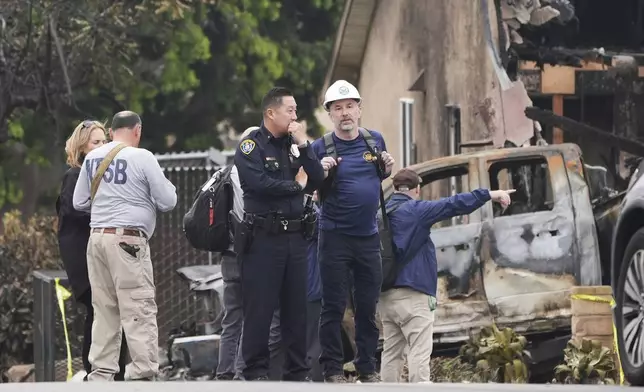 Investigators work at the site of a plane crash Friday, May 23, 2025, in San Diego. (AP Photo/Gregory Bull)
