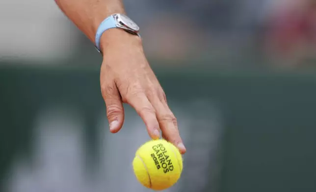 Tommy Paul of the U.S. bounces the ball as he serves against Denmark's Elmer Moller during their first round match of the French Tennis Open at the Roland Garros stadium, in Paris, Sunday May 25, 2025. (AP Photo/Lindsey Wasson)