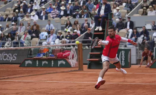 Serbia's Novak Djokovic returns the ball to Mackenzie McDonald of the U.S. during their first round match of the French Tennis Open, at the Roland-Garros stadium, in Paris, Tuesday, May 27, 2025. (AP Photo/Thibault Camus)
