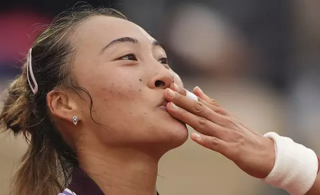 China's Zheng Qinwen blows a kiss as she celebrates after beating Colombia's Emiliana Arango during their second round match of the French Tennis Open, at the Roland-Garros stadium, in Paris, Wednesday, May 28, 2025. (AP Photo/Lindsey Wasson)
