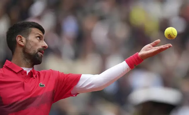 Serbia's Novak Djokovic serves against Mackenzie McDonald of the U.S. during their first round match of the French Tennis Open, at the Roland-Garros stadium, in Paris, Tuesday, May 27, 2025. (AP Photo/Christophe Ena)