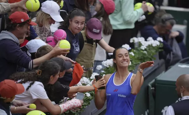 France's Caroline Garcia greets fans after playing her last match of the French Tennis Open, at the Roland-Garros stadium, in Paris, Monday, May 26, 2025. (AP Photo/Thibault Camus)