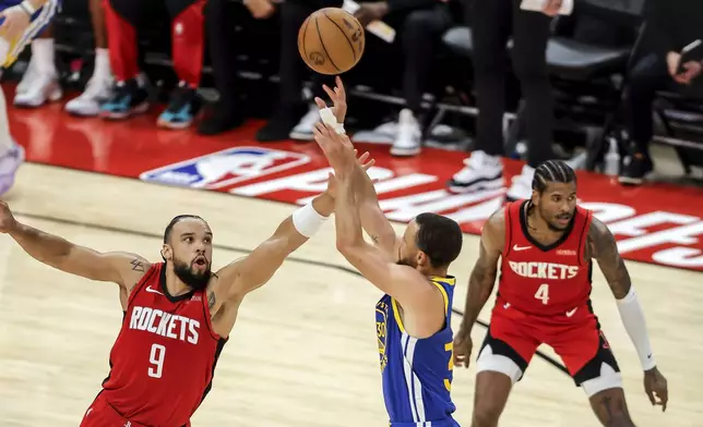 Dillon Brooks (9) goes up to defend against a 3-point shot by Stephen Curry (30) in the first half as the Golden State Warriors played the Houston Rockets in Game 5 of the First Round of the NBA Playoffs at Toyota Center in Houston, Texas on Wednesday, April 30, 2025. (Carlos Avila Gonzalez/San Francisco Chronicle via AP)
