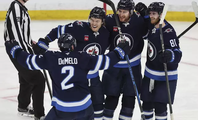 Winnipeg Jets' Dylan DeMelo (2), Vladislav Namestnikov (7), Gabriel Vilardi (13) and Kyle Connor (81) celebrate DeMelo's goal against the St. Louis Blues during second period NHL playoff action in Winnipeg on Wednesday, April 30, 2025. (John Woods/The Canadian Press via AP)