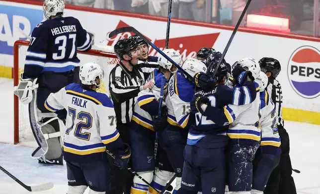 Winnipeg Jets and St. Louis Blues players rough it up after the Blues score during the third period of an NHL playoff game in Winnipeg on Wednesday, April 30, 2025. (John Woods/The Canadian Press via AP)