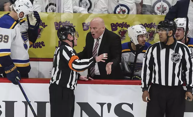 St. Louis Blues head coach Jim Montgomery questions referee Kelly Sutherland during first period NHL playoff action against the Winnipeg Jets in Winnipeg on Wednesday, April 30, 2025. (John Woods/The Canadian Press via AP)