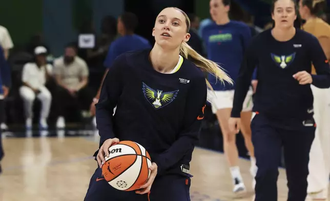 Dallas Wings guard Paige Bueckers warms up before a WNBA basketball game against the Minnesota Lynx, Friday, May 16, 2025, in Arlington, Texas. (AP Photo/Richard Rodriguez)