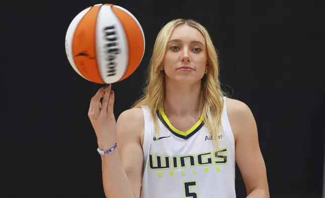 Dallas Wings guard Paige Bueckers poses for photos during a WNBA basketball media day in Arlington, Texas, Wednesday, May 7, 2025. (AP Photo/LM Otero)