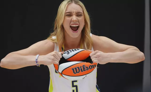Dallas Wings guard Paige Bueckers (5) poses for photos during a WNBA basketball media day in Arlington, Texas, Wednesday, May 7, 2025. (AP Photo/LM Otero)