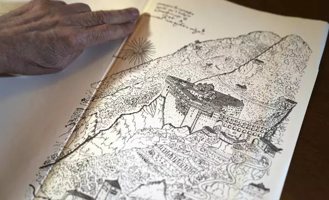 Father Makarios shows a 1744 map depicting the Simonopetra, or the Simonos Petra Monastery, home of the all-male autonomous community Agion Oros, or Holy Mountain, on the peninsula of Mount Athos in northern Greece, Monday, April 14, 2025. (AP Photo/Thanassis Stavrakis)